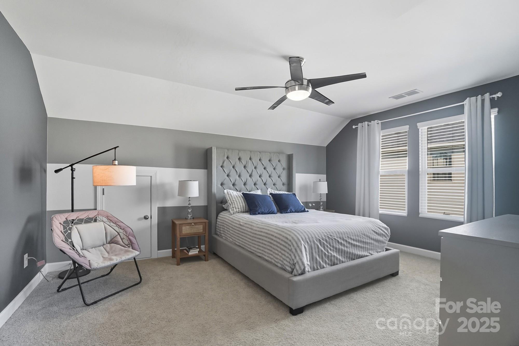 2048 Poplar Ridge Drive Monroe, NC 28110 - Photo 29 of 44 a bedroom with a bed and a chandelier