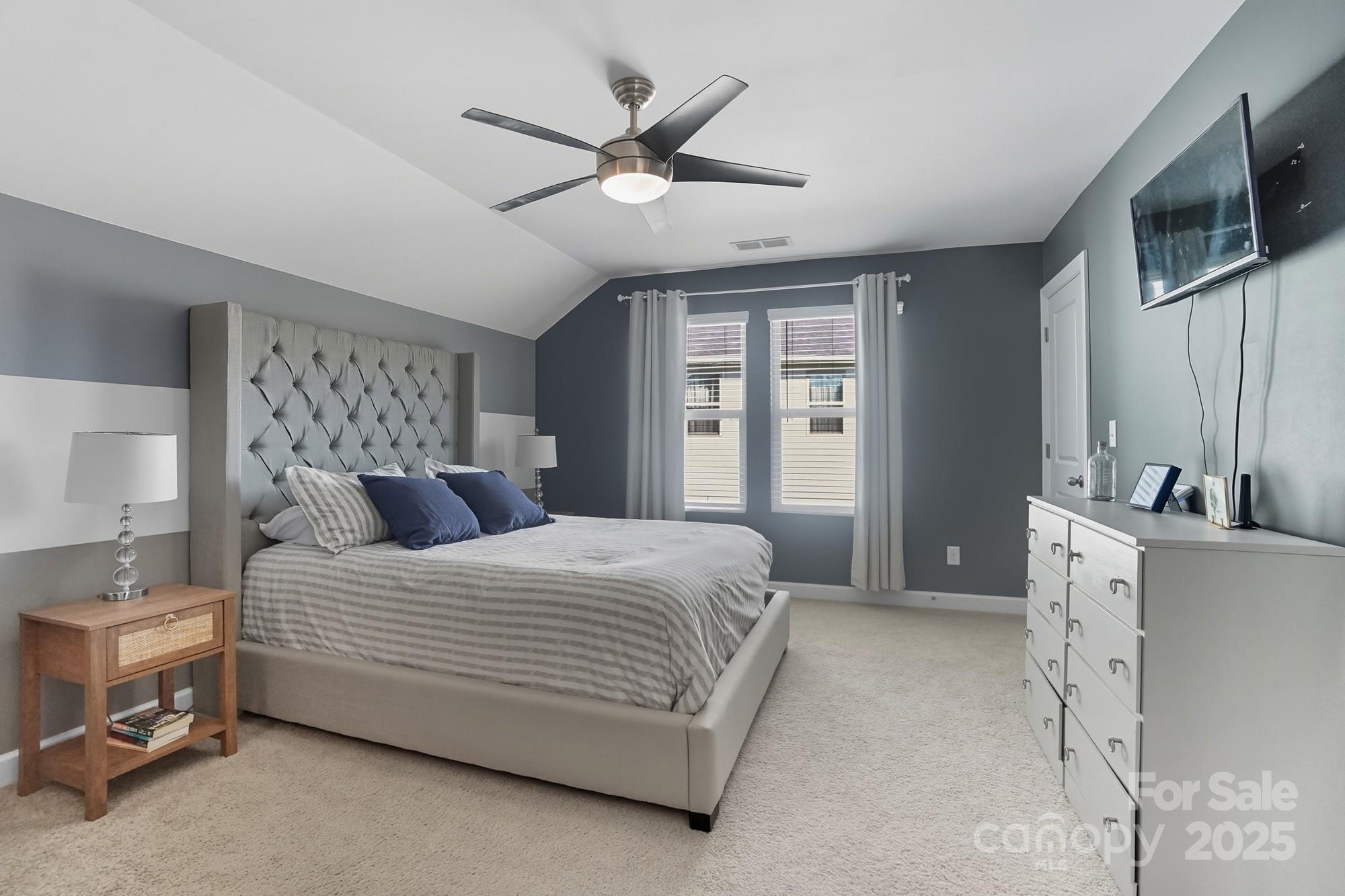 2048 Poplar Ridge Drive Monroe, NC 28110 - Photo 30 of 44 a bedroom with a large bed a flat tv screen and a dresser