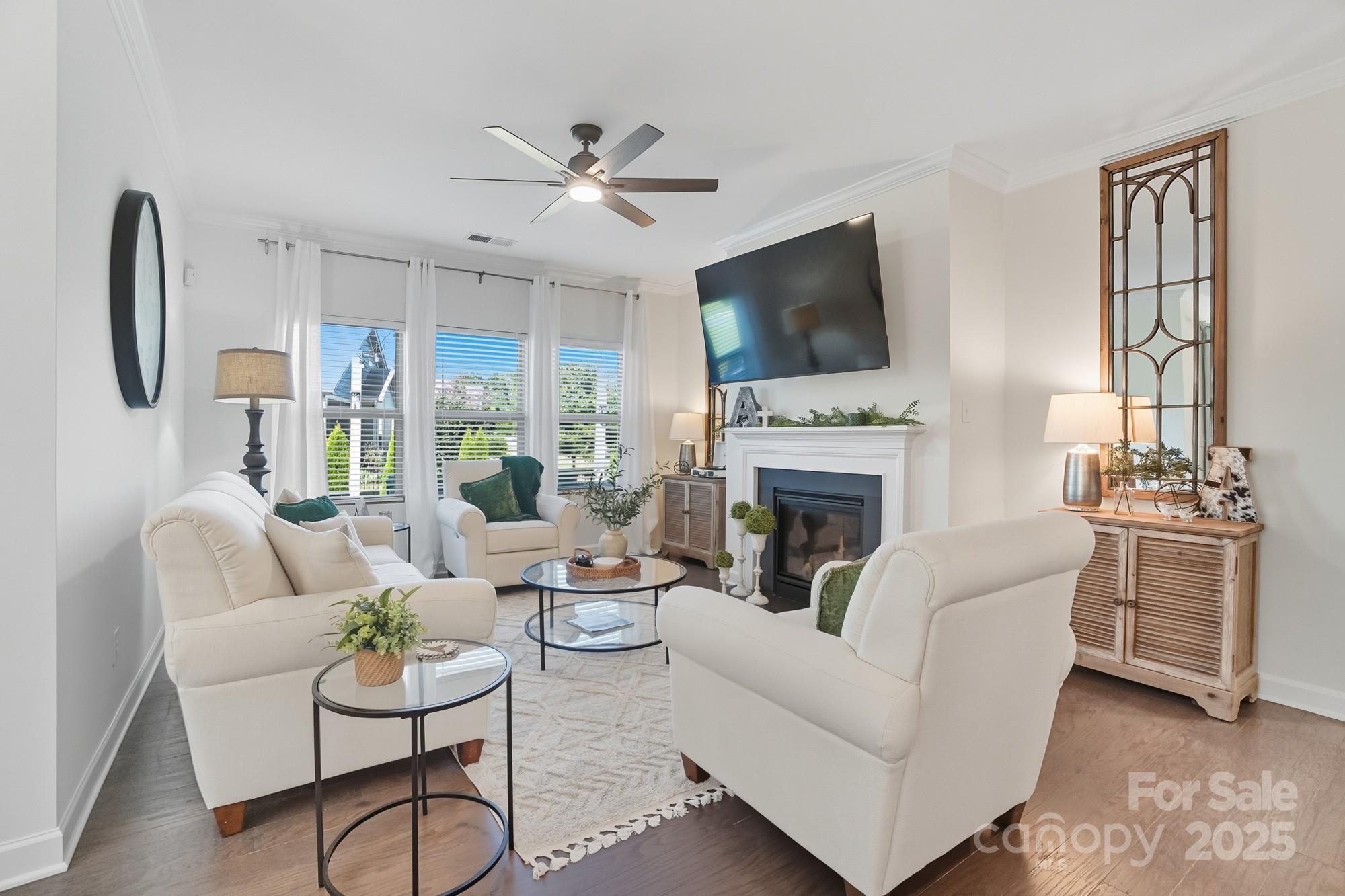 2048 Poplar Ridge Drive Monroe, NC 28110 - Photo 3 of 44 a living room with furniture a fireplace and a flat screen tv