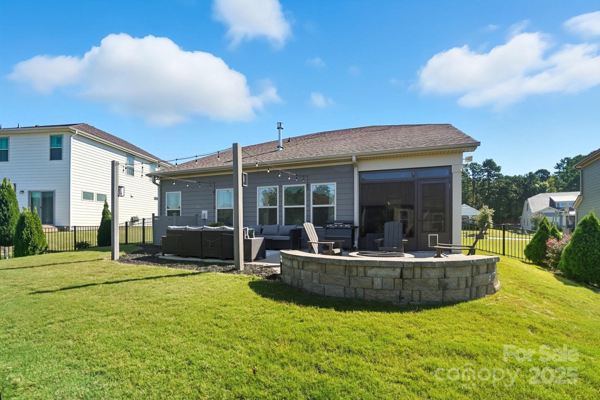 2048 Poplar Ridge Drive Monroe, NC 28110 - Photo 33 of 44 a view of a house with backyard sitting area and porch