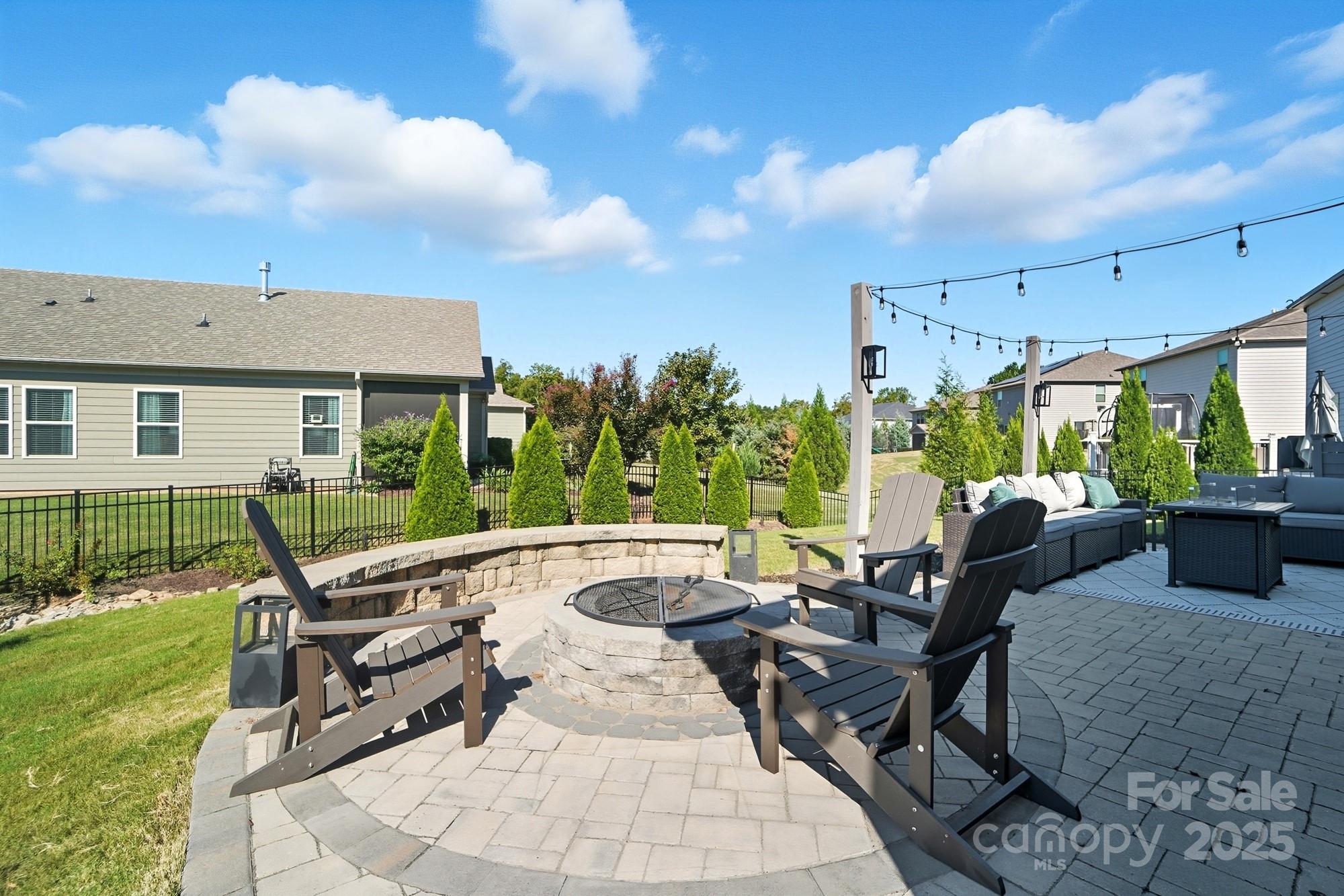 2048 Poplar Ridge Drive Monroe, NC 28110 - Photo 35 of 44 a view of a patio with a dining table and chairs with a patio