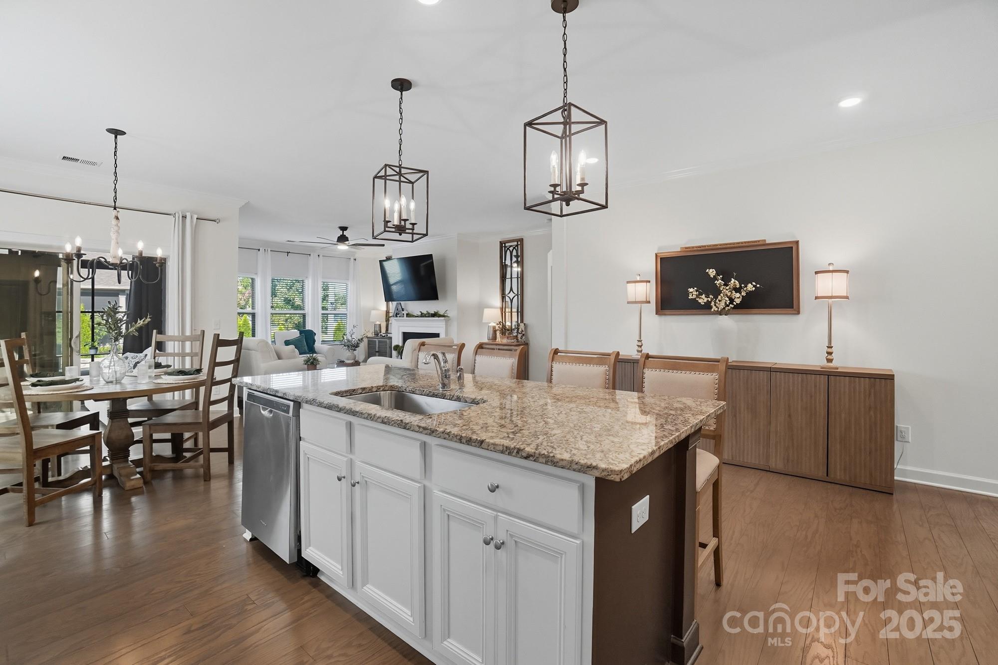 2048 Poplar Ridge Drive Monroe, NC 28110 - Photo 9 of 44 a kitchen with stainless steel appliances granite countertop a kitchen island a stove and a wooden floors