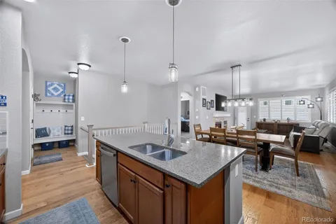 a kitchen with granite countertop a sink a counter space appliances and cabinets