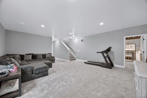 a living room with furniture gym and a window