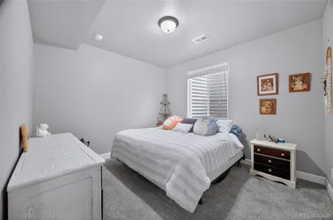 a bedroom with a bed and a tv