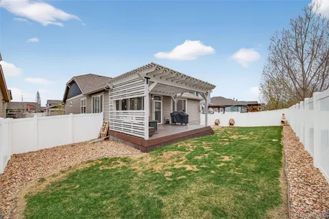 a view of a house with a yard and deck