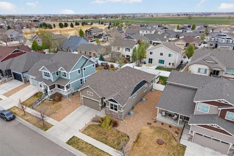an aerial view of residential houses with outdoor space and ocean view