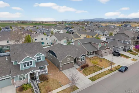 an aerial view of residential house with outdoor space and ocean view
