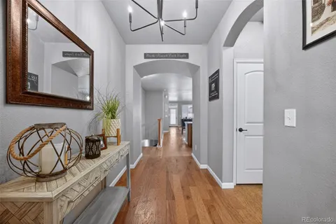 a view of a hallway to a livingroom with furniture