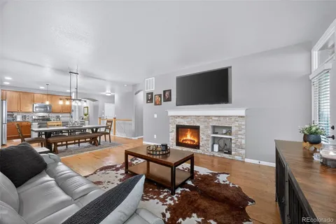a living room with furniture a fireplace and a flat screen tv