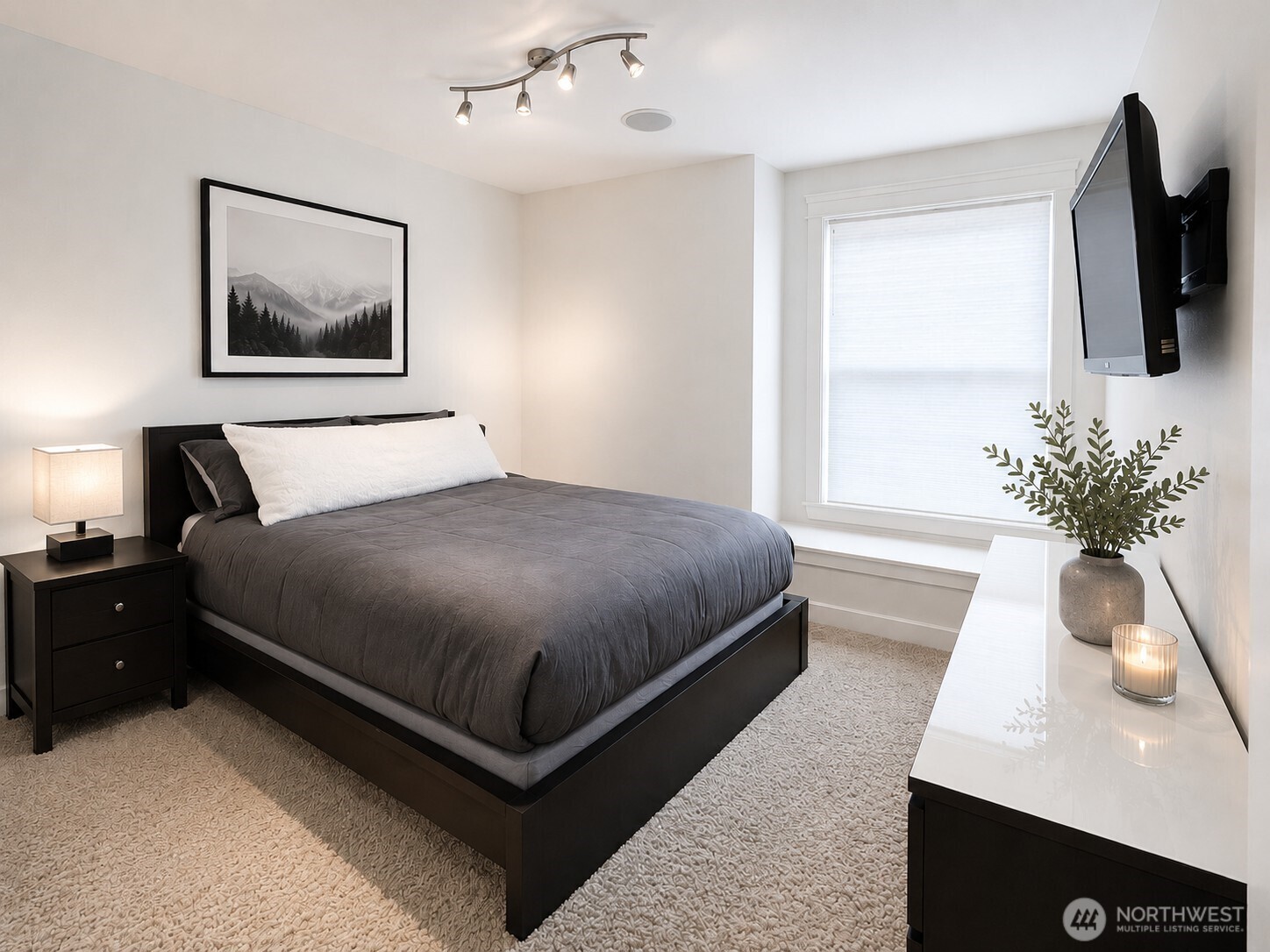 897 Spaulding Circle Buckley, WA 98321 - Photo 26 of 40 a bedroom with a large bed and a potted plant
