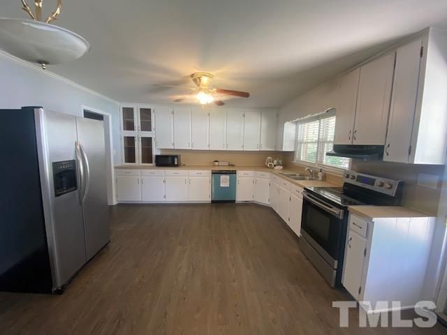 200 South 11th Street Erwin, NC 28339 - Photo 2 of 20 a large kitchen with stainless steel appliances granite countertop a stove refrigerator sink and dishwasher