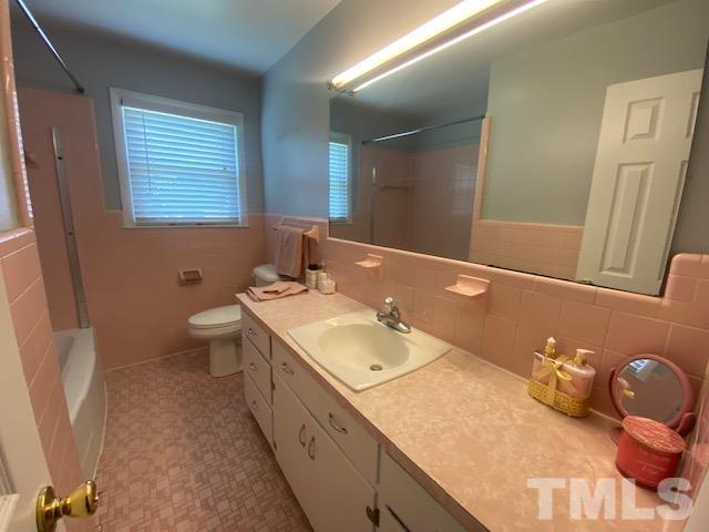 200 South 11th Street Erwin, NC 28339 - Photo 12 of 20 a bathroom with a granite countertop sink and a mirror