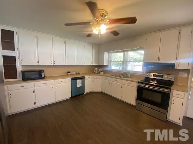 200 South 11th Street Erwin, NC 28339 - Photo 3 of 20 a kitchen with granite countertop white cabinets and white appliances