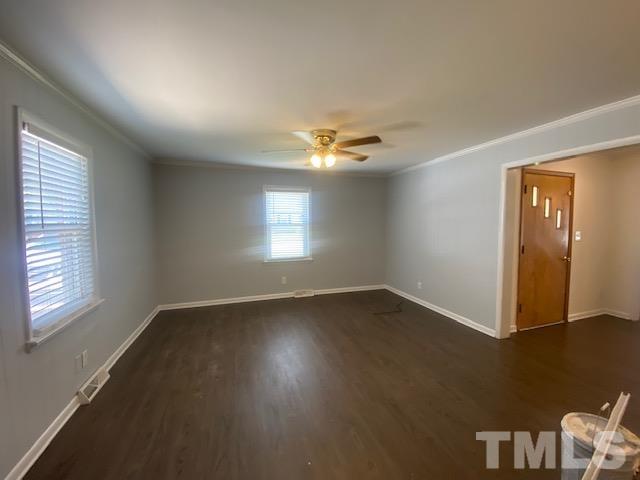 200 South 11th Street Erwin, NC 28339 - Photo 4 of 20 a view of an empty room with wooden floor and a window