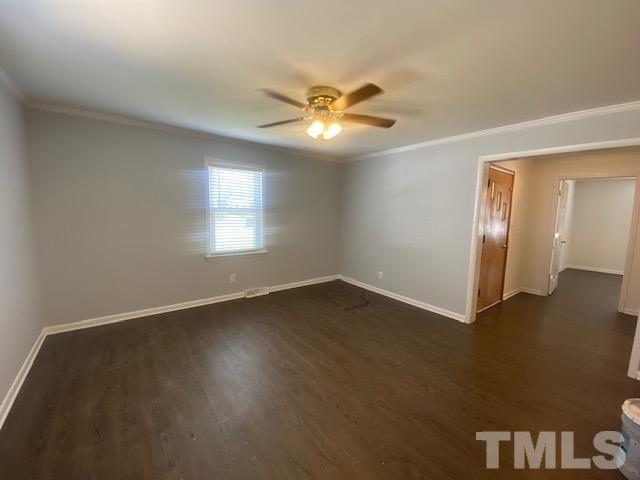 200 South 11th Street Erwin, NC 28339 - Photo 5 of 20 a view of an empty room with window and wooden floor