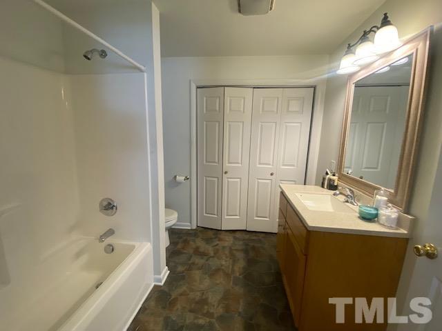 200 South 11th Street Erwin, NC 28339 - Photo 8 of 20 a bathroom with a bathtub shower sink and mirror