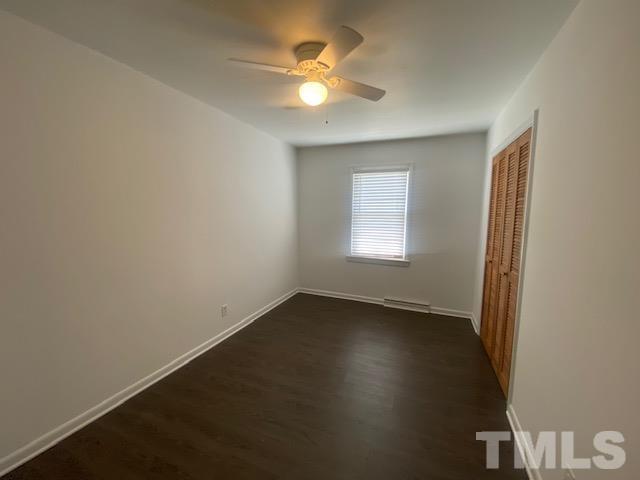 200 South 11th Street Erwin, NC 28339 - Photo 10 of 20 an empty room with a window and a ceiling fan