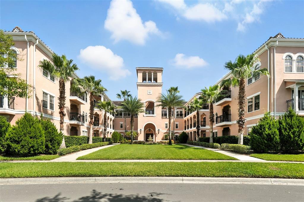 211 Longview Avenue, Unit 306 Celebration, FL 34747 - Photo 1 of 1 a view of a white building among the street and palm trees