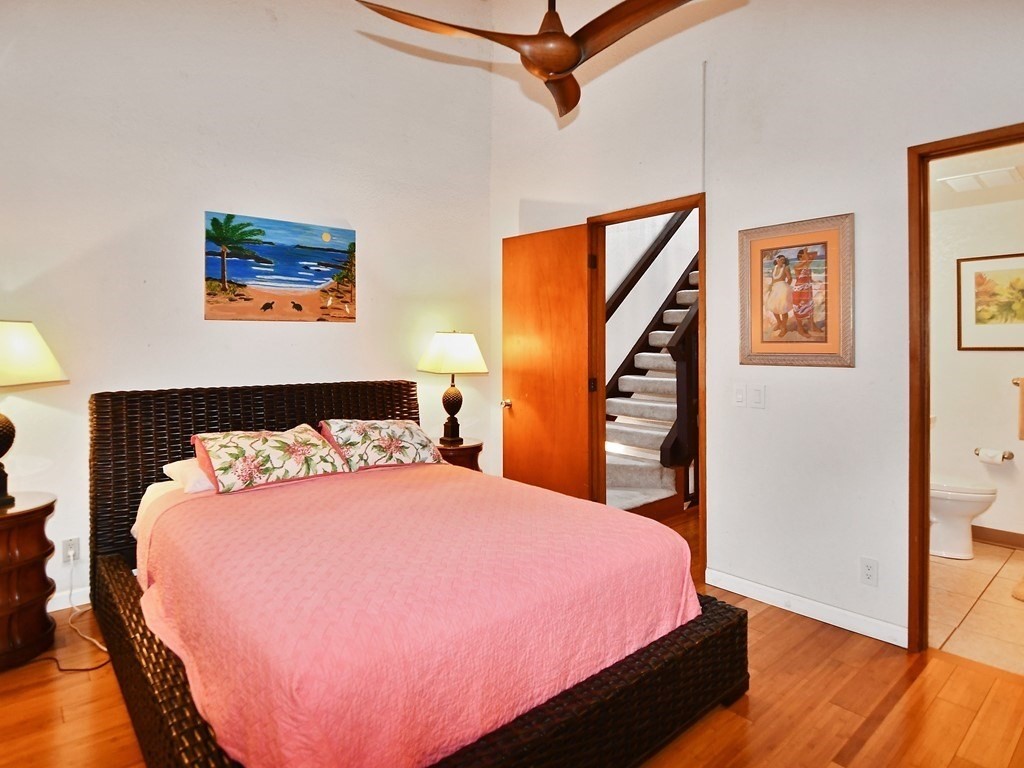 1661 Pee Road, Unit I303 Koloa, HI 96756 - Photo 14 of 15 a bedroom with a bed and wooden floor