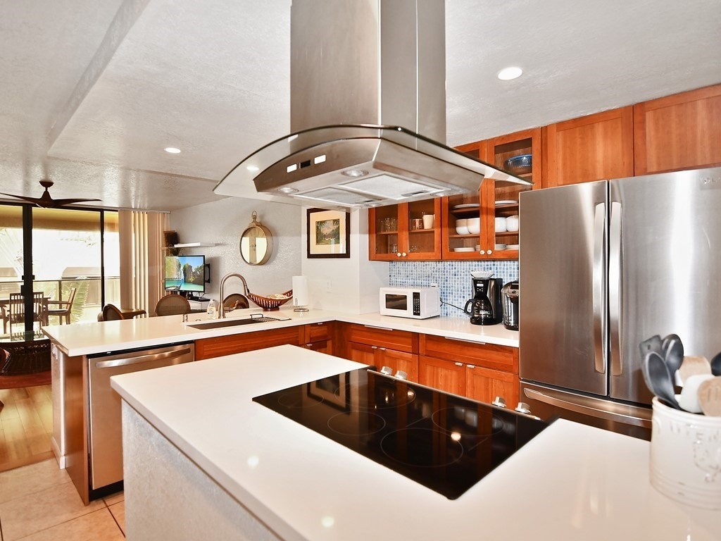 1661 Pee Road, Unit I303 Koloa, HI 96756 - Photo 2 of 15 a kitchen with stainless steel appliances a sink and a refrigerator