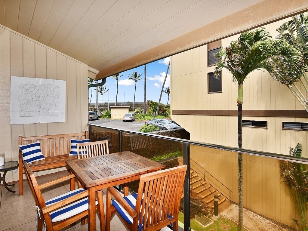1661 Pee Road, Unit I303 Koloa, HI 96756 - Photo 6 of 15 a dining room with furniture and a floor to ceiling window