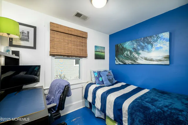 a bedroom with a bed and a chair