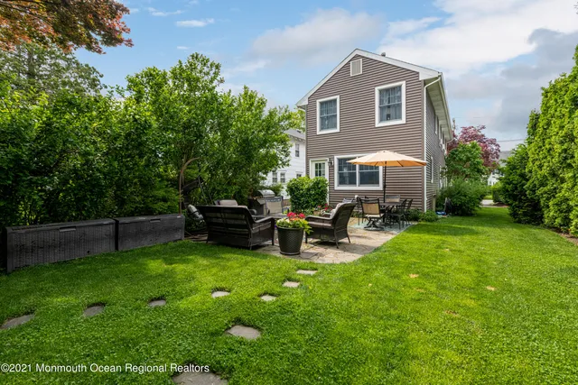 a front view of a house with patio and garden