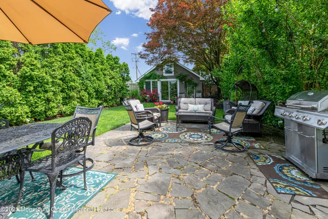 a view of a chairs and table in backyard