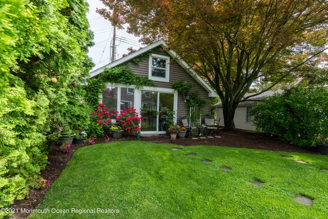 a view of a house with a yard and sitting area