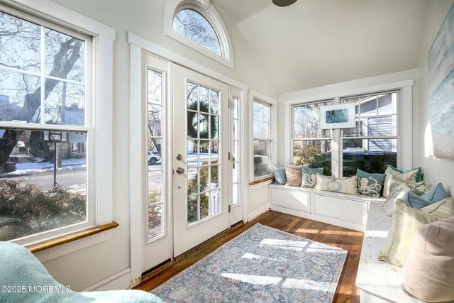 a living room with furniture and large windows