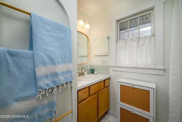 a bathroom with a sink a mirror and a toilet