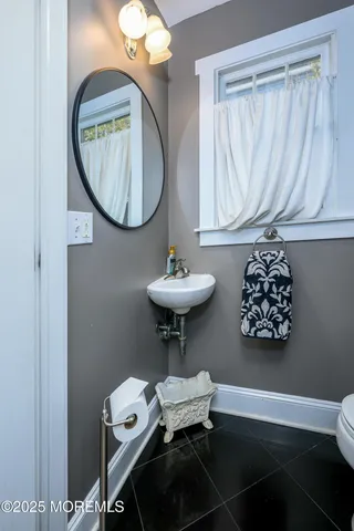 a front view of a house with a yard and potted plants