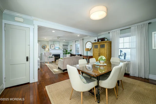 a dining room with furniture and wooden floor