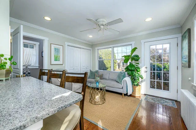 a kitchen with a table chairs and wooden floor