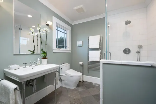a bathroom with a sink and mirror with toilet