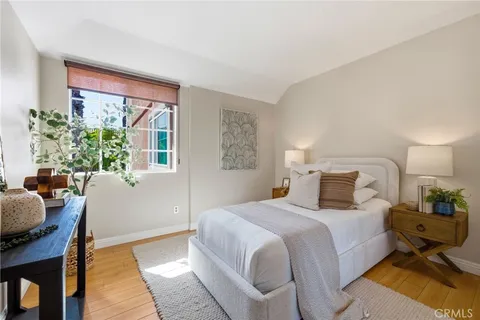 a bedroom with a bed and windows