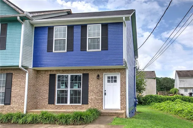 a front view of a house with garden