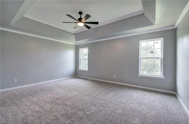 a view of an empty room and a ceiling fan