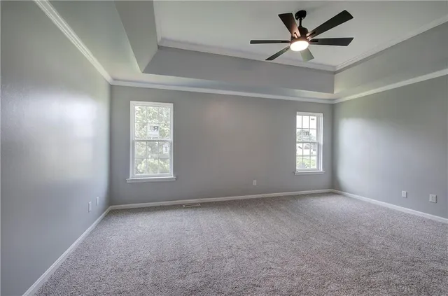 a bathroom with a granite countertop sink a toilet and a mirror