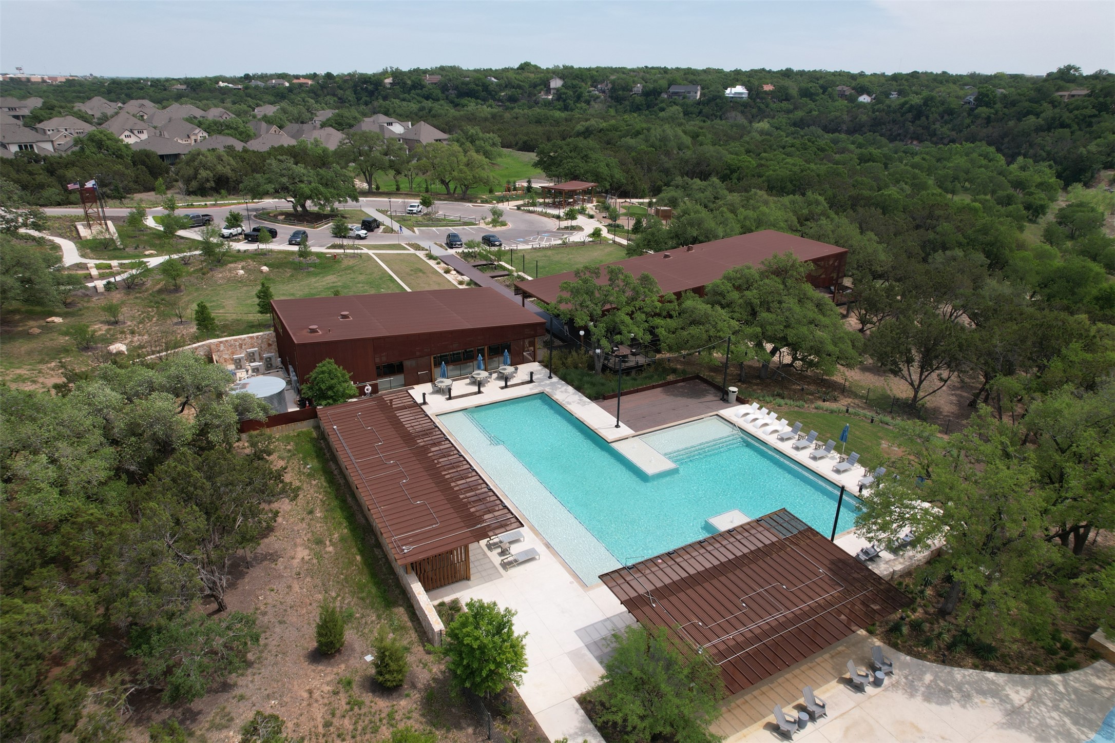 124 Cherry Ridge Road Georgetown, TX 78628 - Photo 23 of 23 Expansive community pool with integrated tanning ledges, surrounded by a concrete deck and shaded pergolas