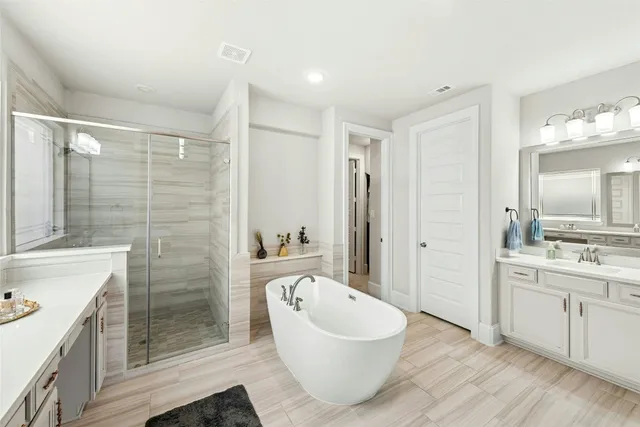 a large white kitchen with a sink and cabinets