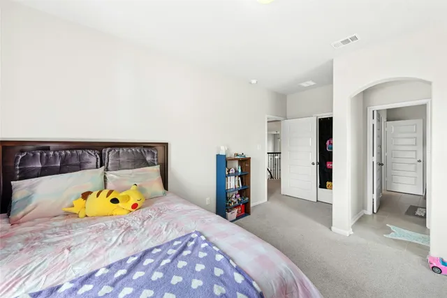 a bed room with a bed and a window