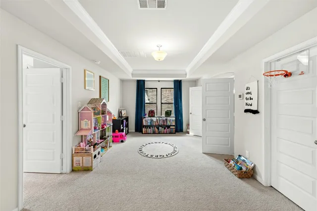 a bedroom with a bed and a large mirror