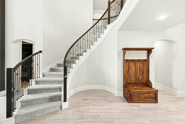 a view of entryway and hall with wooden floor