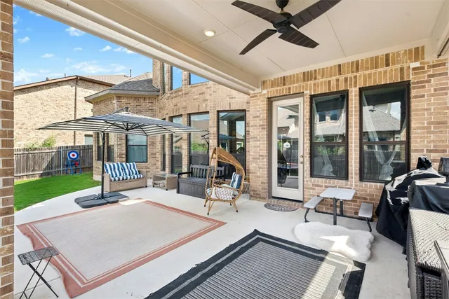 a view of a patio with a table and chairs