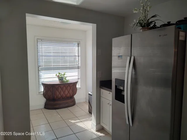 a living room with a bed and a window