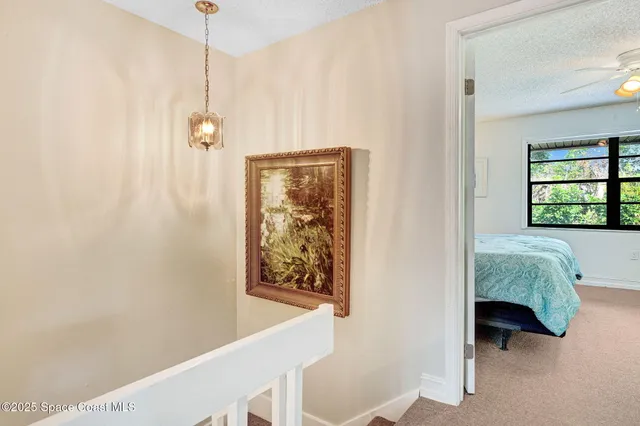 a bedroom with a bed table and a window