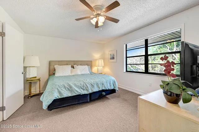 a view of a bedroom with window and cabinet