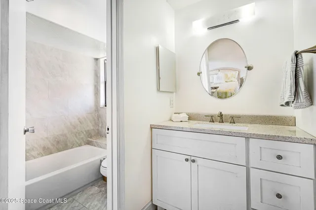 a living room with furniture and entryway